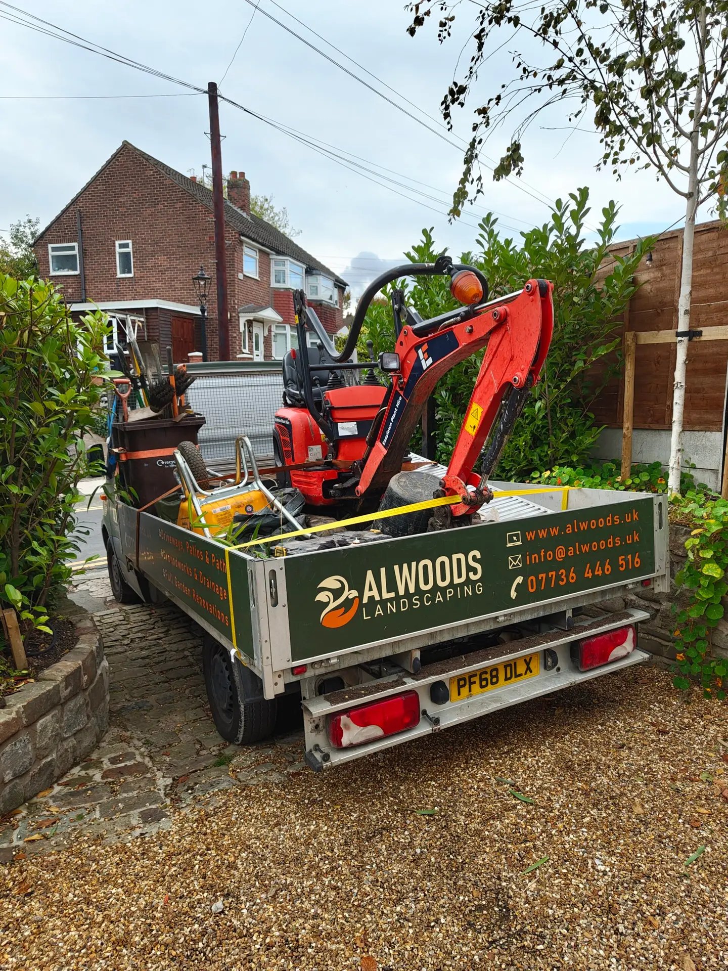 alwoods landscaping wagon carrying an excavator